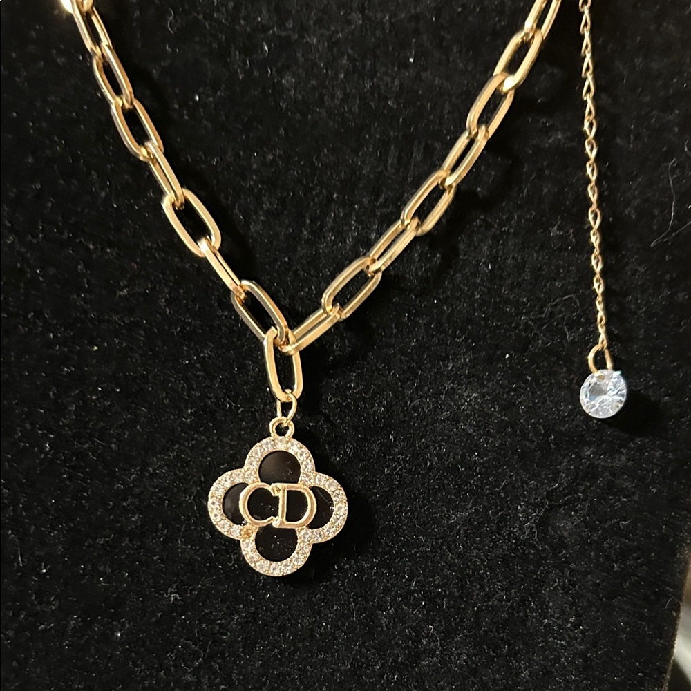 Elegant Gold Necklace with Black and Gold Pendant